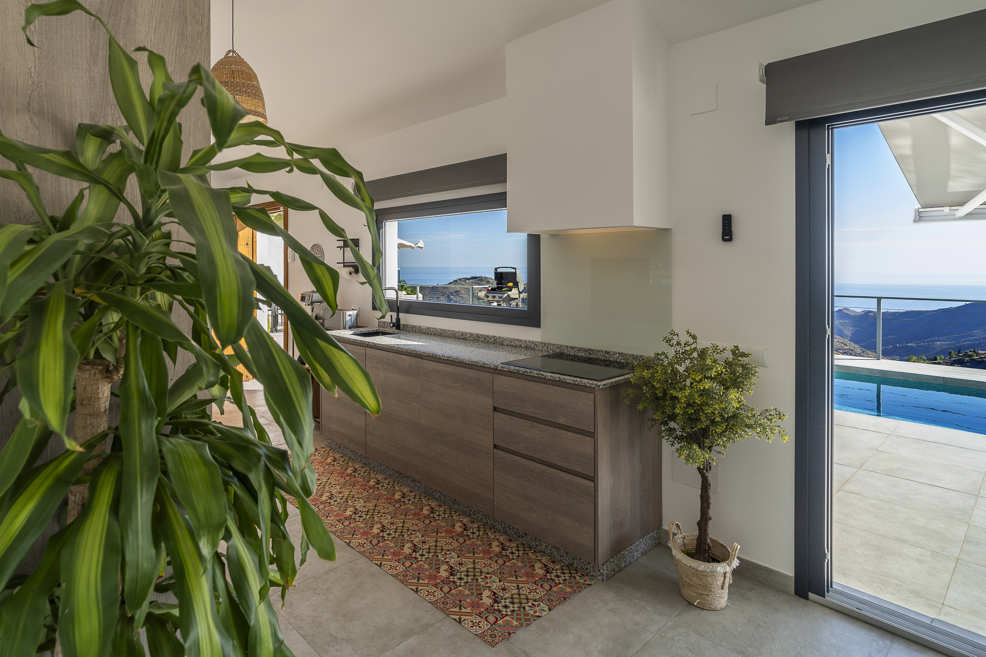 Kitchen with terrace and pool views